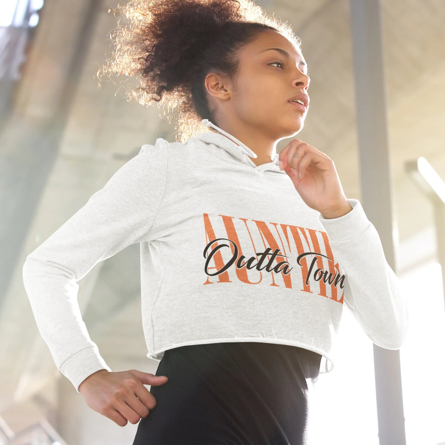 mockup of a woman wearing a crop top hoodie while jogging